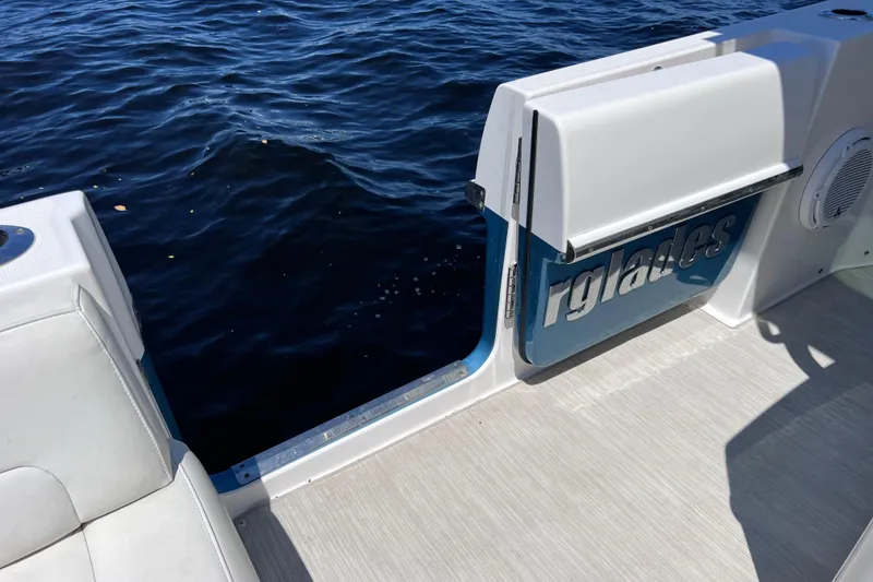 Slide: The Image of 2017 Everglades 360LXC boat with open side door, overlooking water. - 34