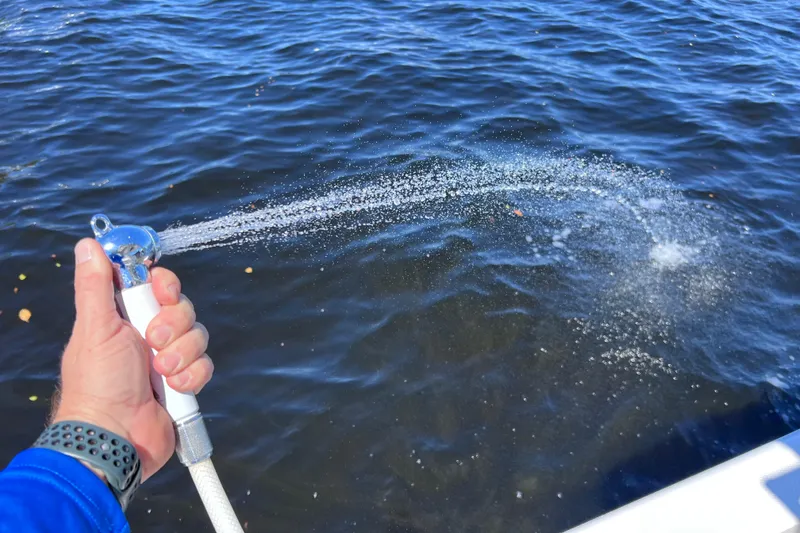 Slide: The Image of Hand spraying water from Everglades 360LXC boat, 2017 model, onto blue ocean surface. - 35