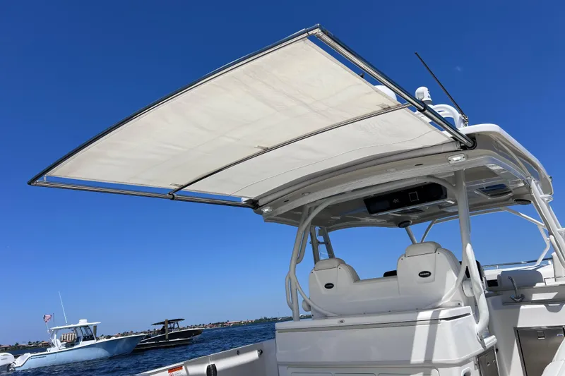 Slide: The Image of 2017 Everglades 360LXC boat with sunshade, on a clear blue water day. - 38
