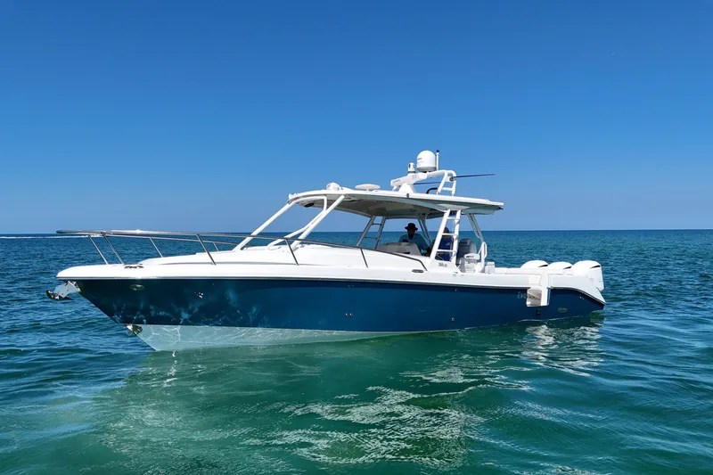 Slide: The Image of 2017 Everglades 360LXC boat cruising on clear blue ocean waters. - 4