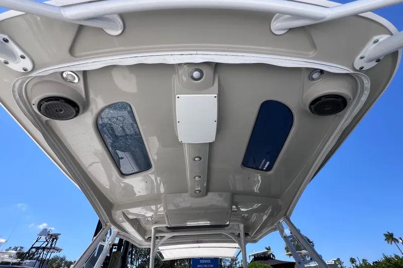 Slide: The Image of 2017 Everglades 360LXC boat roof with speakers and skylights under clear blue sky. - 43