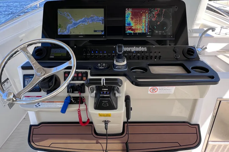 Slide: The Image of Control panel of 2017 Everglades 360LXC boat with navigation screens and steering wheel. - 44