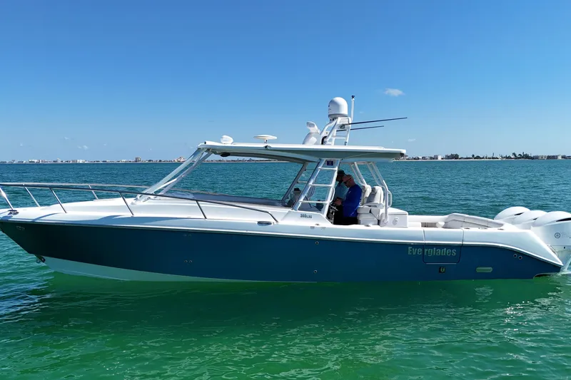 Slide: The Image of 2017 Everglades 360LXC boat cruising on clear blue water under a sunny sky. - 5