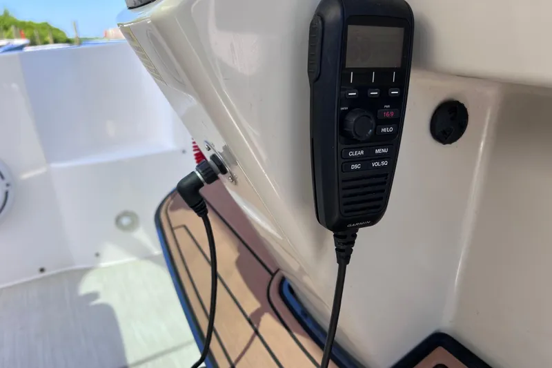Slide: The Image of VHF radio on 2017 Everglades 360LXC boat, featuring Garmin communication device. - 59