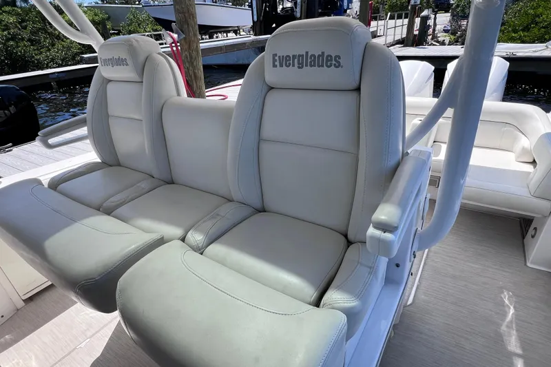 Slide: The Image of 2017 Everglades 360LXC boat seats, white leather, docked in marina. - 62