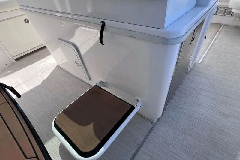 Slide: The Image of 2017 Everglades 360LXC boat interior with foldable step and storage compartment. - 64