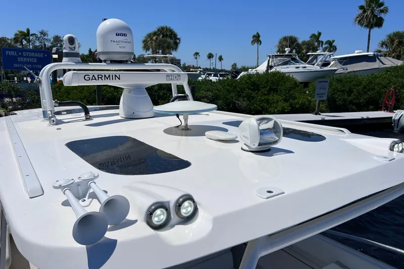 Slide: The Image of 2017 Everglades 360LXC boat with Garmin xHD2 radar, docked near palm trees. - 67