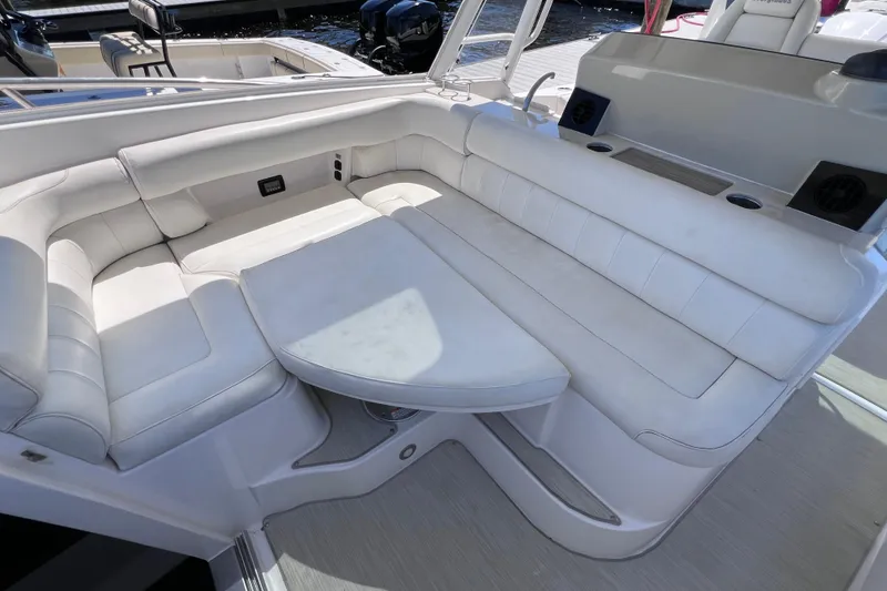 Slide: The Image of Luxurious seating area on a 2017 Everglades 360LXC boat, featuring white cushioned seats. - 71