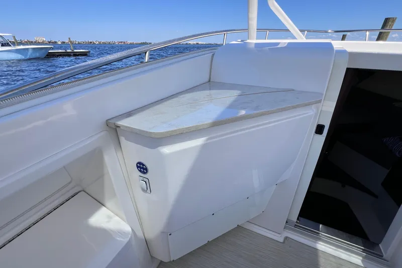 Slide: The Image of 2017 Everglades 360LXC boat interior with sleek countertop and water view. - 72