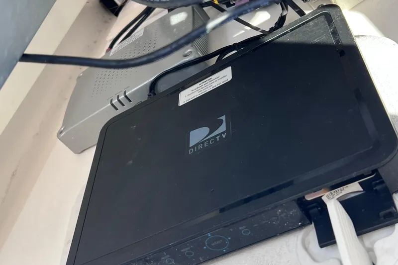 Slide: The Image of DirecTV receiver installed on a 2017 Everglades 360LXC boat, with connected cables. - 75