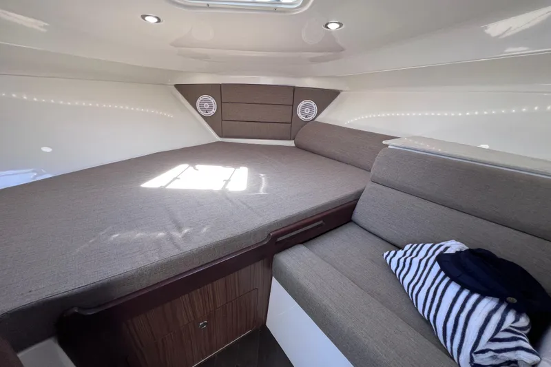 Slide: The Image of Cozy cabin interior of 2017 Everglades 360LXC boat with comfortable seating and natural light. - 78