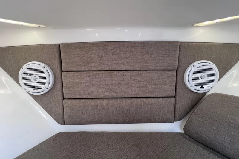 Slide: The Image of Interior of 2017 Everglades 360LXC boat with cushioned seating and built-in speakers. - 79