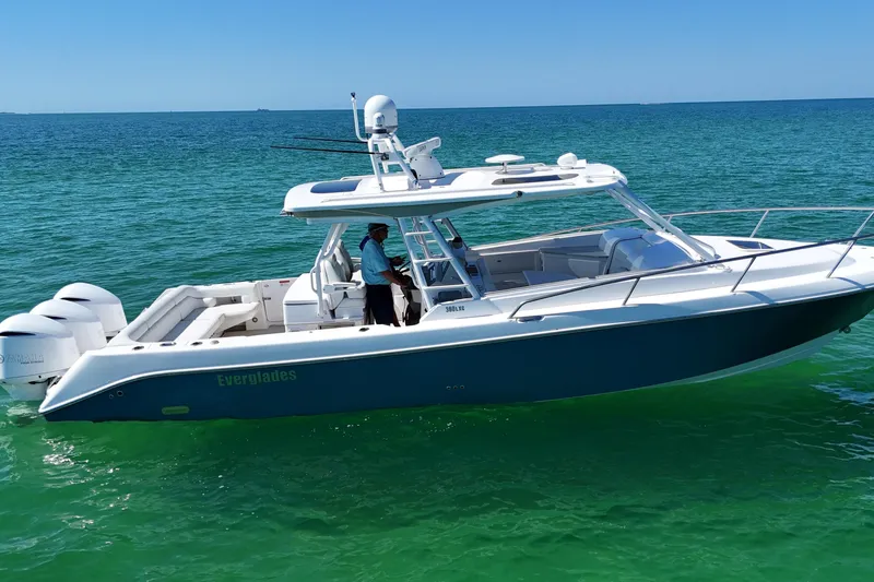 Slide: The Image of 2017 Everglades 360LXC boat cruising on clear blue water. - 8
