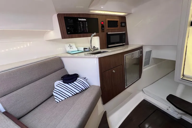 Slide: The Image of Interior of 2017 Everglades 360LXC boat with kitchenette and seating area. - 81