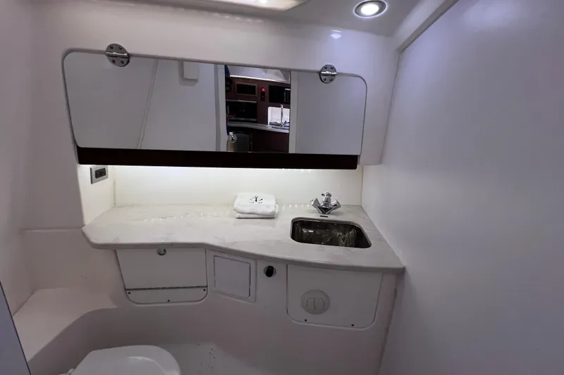 Slide: The Image of 2017 Everglades 360LXC boat bathroom with sink, mirror, and countertop. - 85