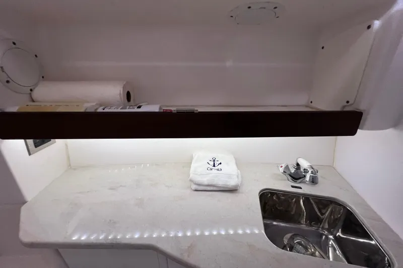 Slide: The Image of 2017 Everglades 360LXC boat interior with sink, countertop, and towel. - 86