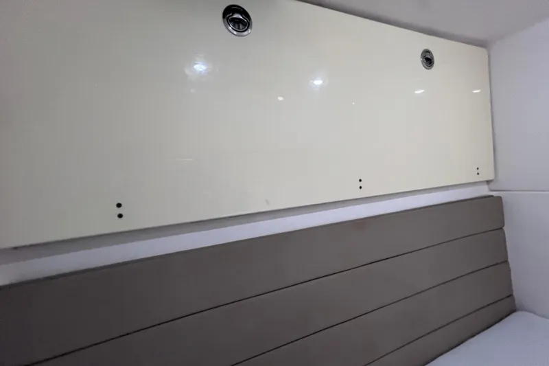 Slide: The Image of Interior view of a 2017 Everglades 360LXC boat cabin with beige paneling. - 88