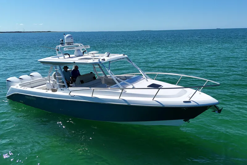 Slide: The Image of 2017 Everglades 360LXC boat cruising on clear blue water. - 9