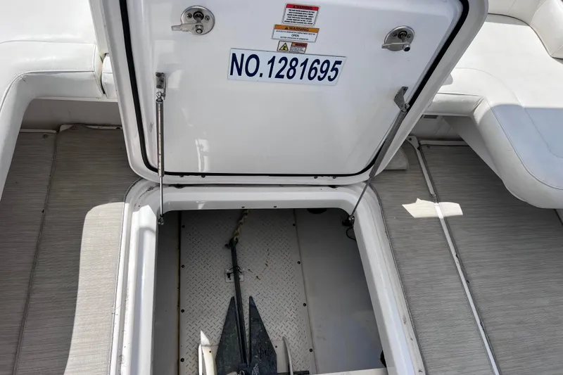 Slide: The Image of Open storage compartment on 2017 Everglades 360LXC boat, showing anchor inside. - 90