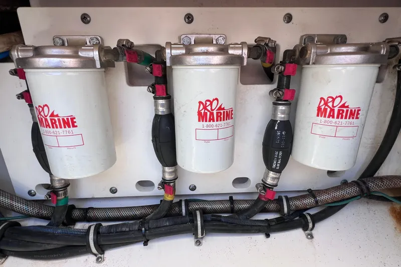 Slide: The Image of Fuel filters and hoses in a 2017 Everglades 360LXC boat engine compartment. - 94