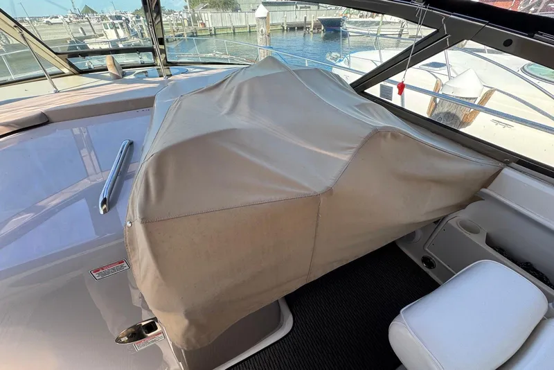 Slide: The Image of 2004 Sea Ray 360 Sundancer cockpit with covered helm station, docked at marina. - 10