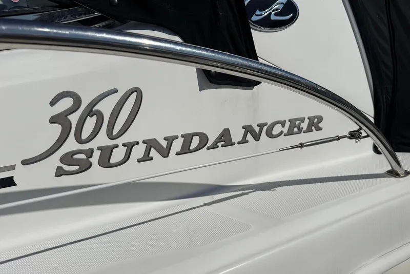 Slide: The Image of 2004 Sea Ray 360 Sundancer boat nameplate with sleek design and chrome accents. - 11