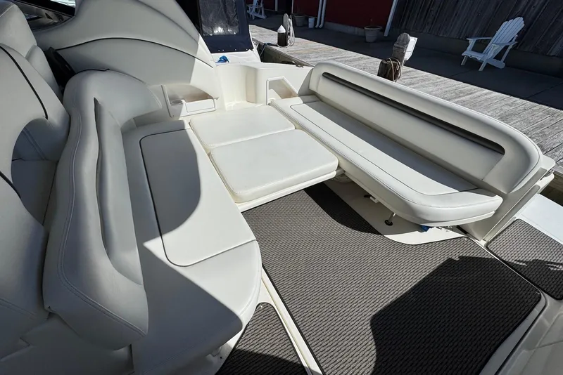 Slide: The Image of 2004 Sea Ray 360 Sundancer interior with white leather seating and carpeted flooring. - 14