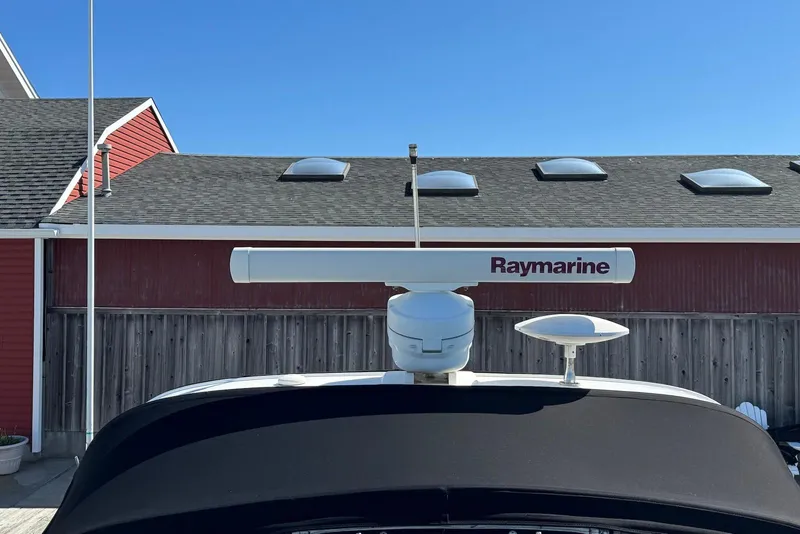 Slide: The Image of Raymarine radar on 2004 Sea Ray 360 Sundancer against blue sky and red building. - 18