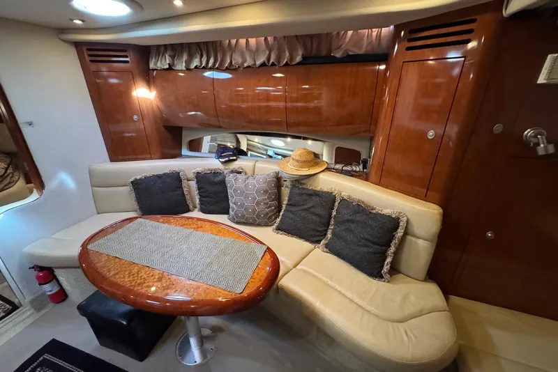 Slide: The Image of Luxurious interior of 2004 Sea Ray 360 Sundancer yacht with plush seating and wooden accents. - 21