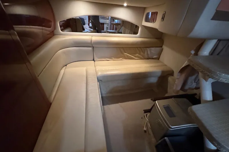 Slide: The Image of Interior of 2004 Sea Ray 360 Sundancer with beige seating and compact design. - 26