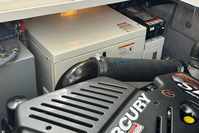 Slide: The Image of Engine compartment of a 2004 Sea Ray 360 Sundancer with Mercury components visible. - 30