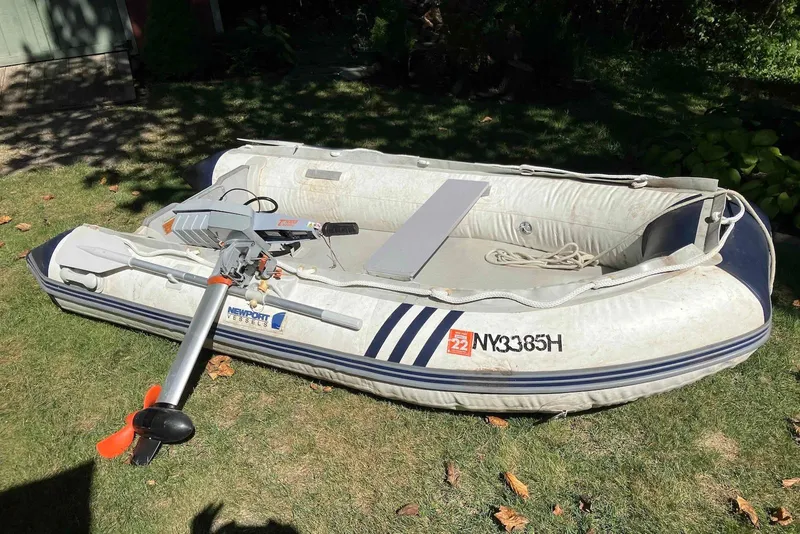 Slide: The Image of Inflatable boat with Newport Vessels motor on grass, featuring registration number NY3385H. - 31