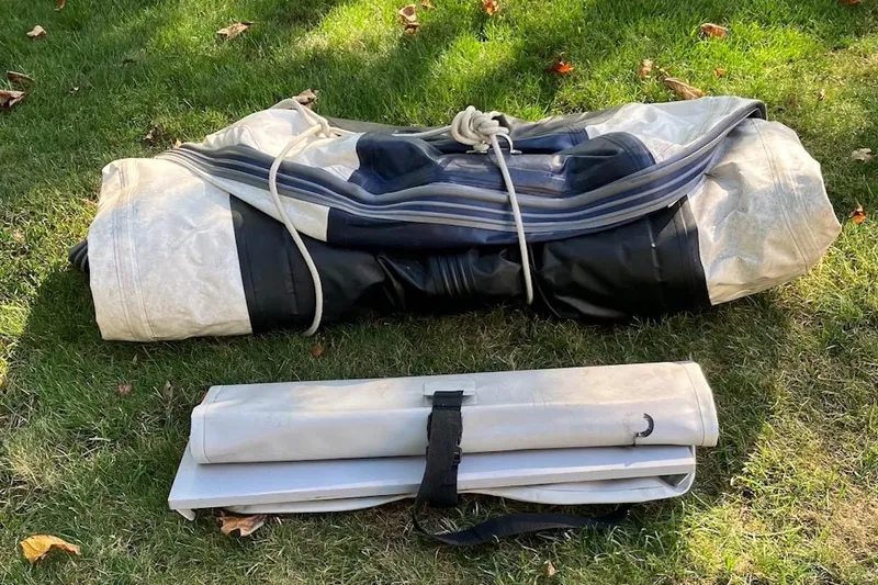 Slide: The Image of Folded inflatable boat on grass, compatible with 2004 Sea Ray 360 Sundancer. - 32