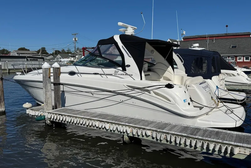 Slide: The Image of 2004 Sea Ray 360 Sundancer docked at marina under clear blue sky. - 4