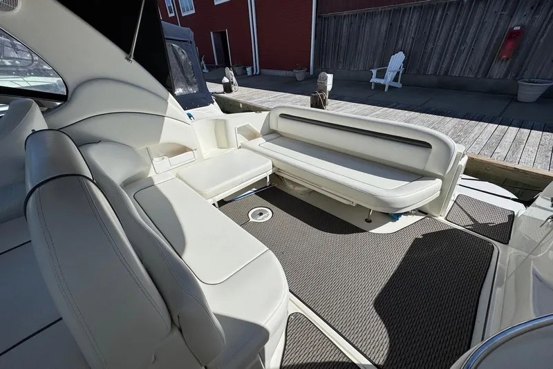 Slide: The Image of 2004 Sea Ray 360 Sundancer boat interior with white seating and carpeted floor. - 7