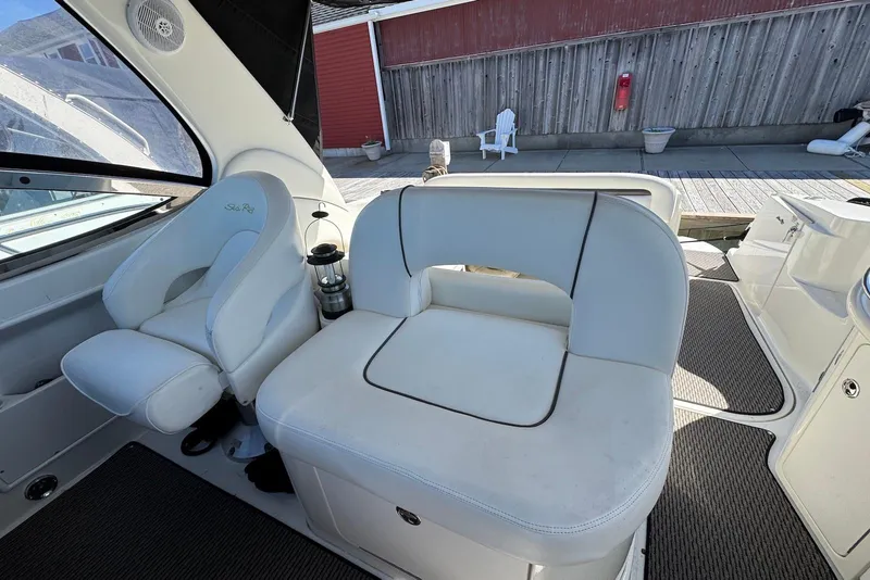 Slide: The Image of 2004 Sea Ray 360 Sundancer interior with white seating and dock view. - 8