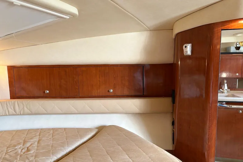 Slide: The Image of 2007 Sea Ray 340 Sundancer cabin interior with wood paneling and beige upholstery. - 21