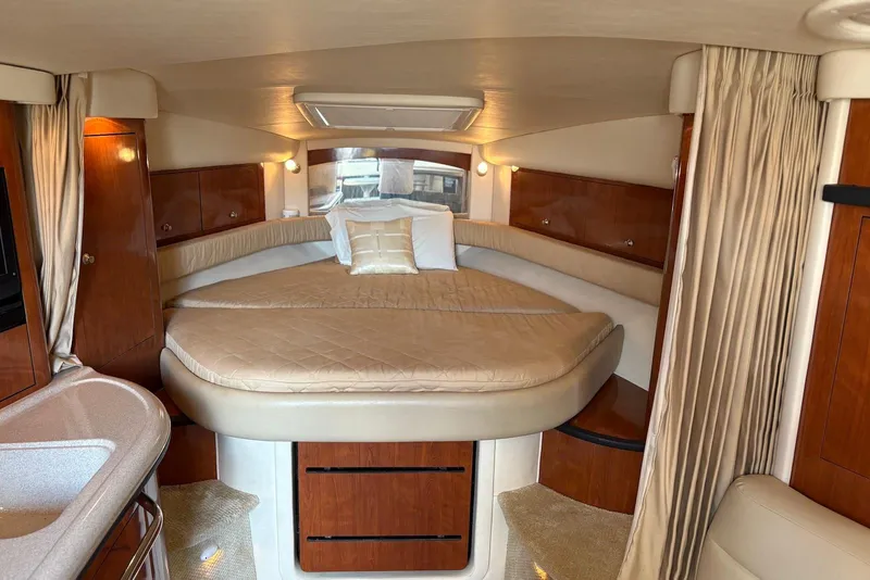 Slide: The Image of Luxurious interior cabin of 2007 Sea Ray 340 Sundancer with elegant bedding and wood finishes. - 28
