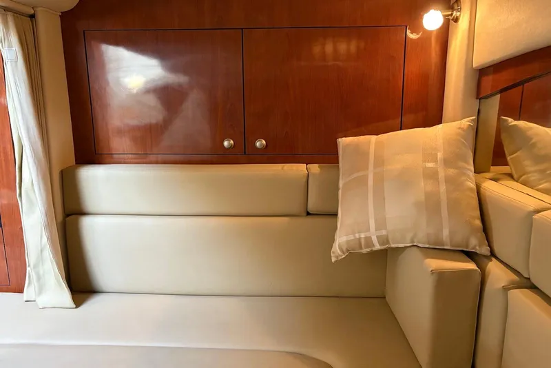 Slide: The Image of Interior of 2007 Sea Ray 340 Sundancer with beige seating and wooden cabinetry. - 31