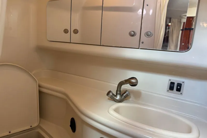 Slide: The Image of 2007 Sea Ray 340 Sundancer bathroom with sink, mirror, and storage cabinets. - 34