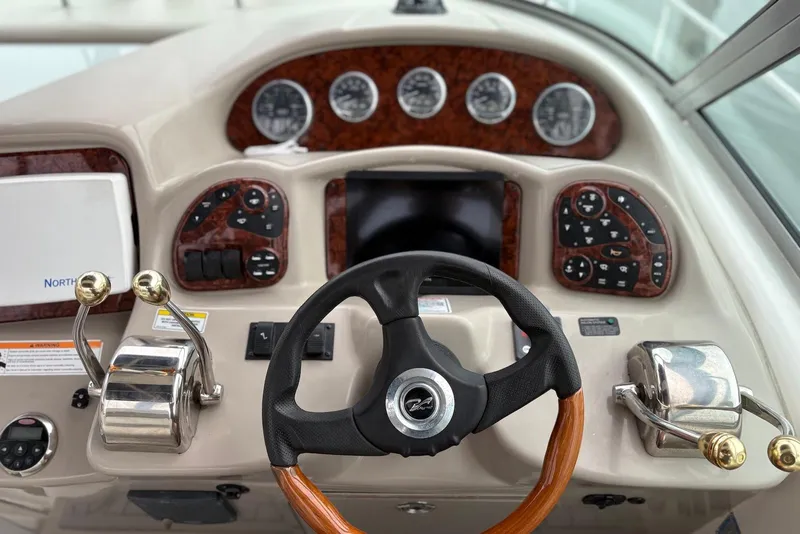 Slide: The Image of 2007 Sea Ray 340 Sundancer helm with steering wheel, gauges, and controls. - 4