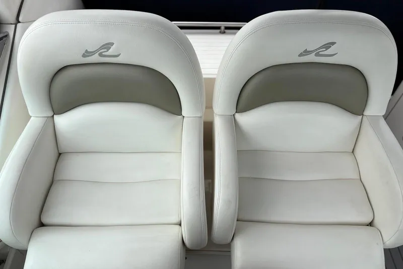 Slide: The Image of Two white leather seats on a 2007 Sea Ray 340 Sundancer boat. - 5