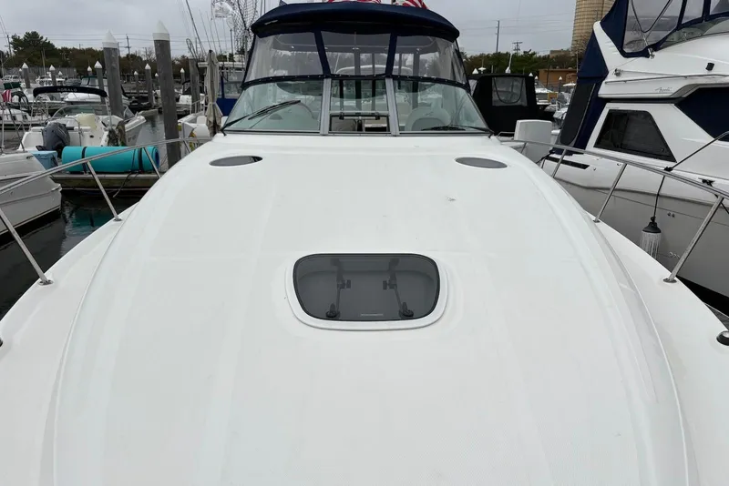 Slide: The Image of 2007 Sea Ray 340 Sundancer yacht docked at marina, showcasing sleek deck design. - 7