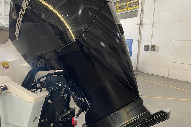 Slide: The Image of 2021 Key West 239 DFS boat with Mercury outboard motor in a warehouse setting. - 12