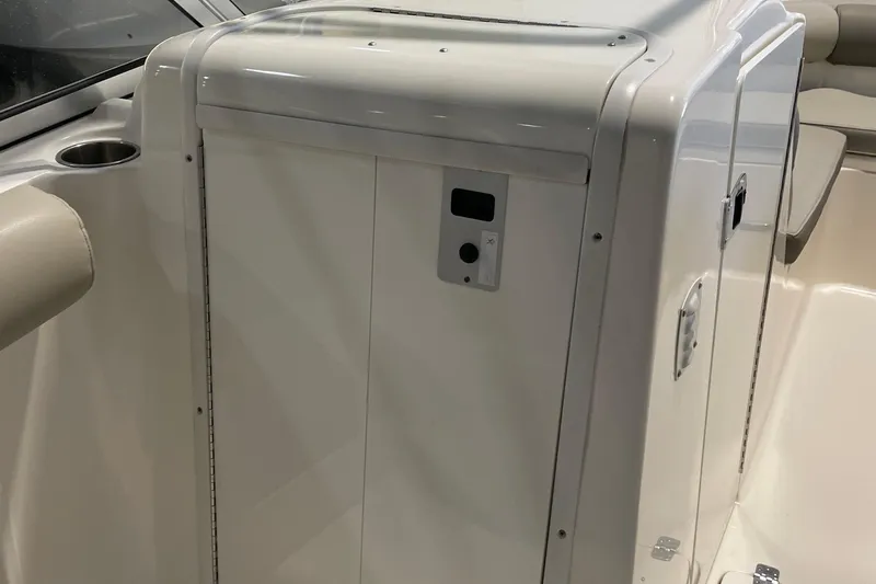 Slide: The Image of 2021 Key West 239 DFS boat interior, featuring a sleek white console and seating area. - 19