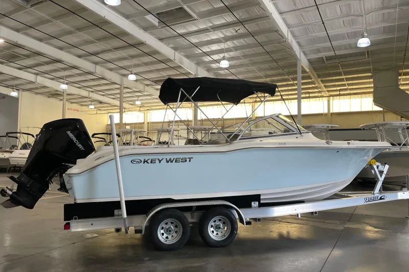 Slide: The Image of 2021 Key West 239 DFS boat on trailer in indoor showroom. - 2