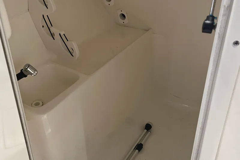 Slide: The Image of Interior of a 2021 Key West 239 DFS boat, featuring storage space and fixtures. - 20