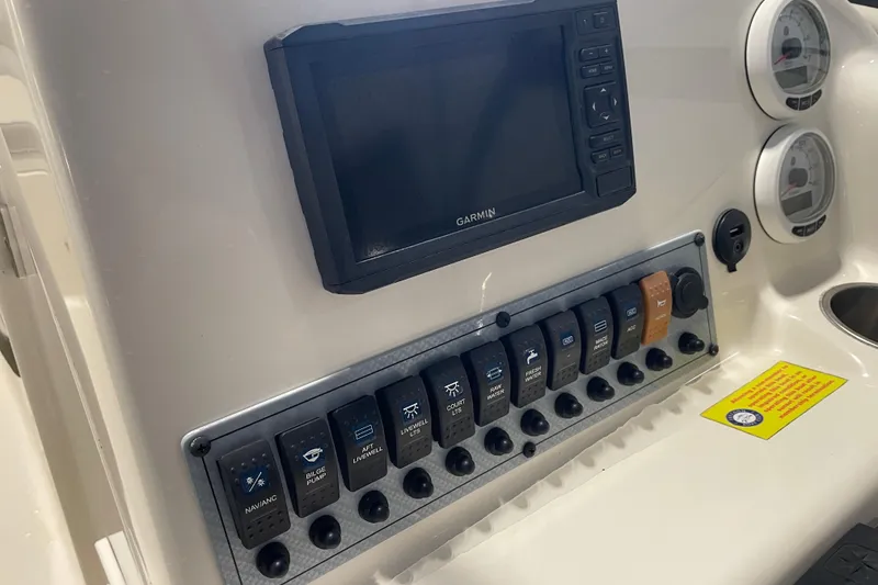 Slide: The Image of 2021 Key West 239 DFS boat dashboard with Garmin display and control switches. - 22