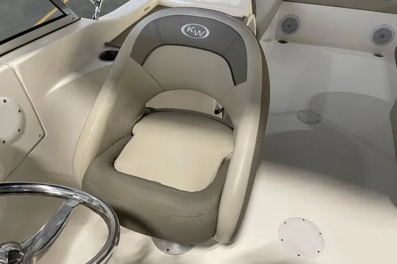 Slide: The Image of 2021 Key West 239 DFS boat interior with cushioned seat and steering wheel. - 26