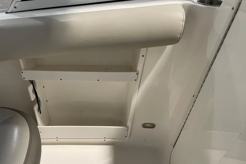 Slide: The Image of Interior detail of 2021 Key West 239 DFS boat, featuring storage compartment and seating. - 28